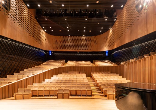 The public enters the oak-lined from the ground floor and spiraling ramps lead them to their golden seats.