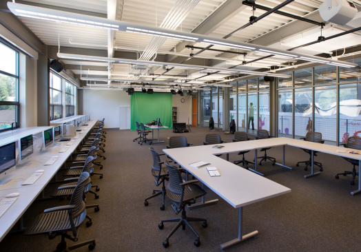 Flexible classroom space enables the curriculum to evolve; in the media classroom, a green-screen setup and visibility from the gallery.