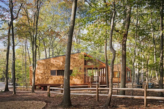 The cabins’ Shakertown cedar shingle panels will weather over time to blend with the surrounding forest.