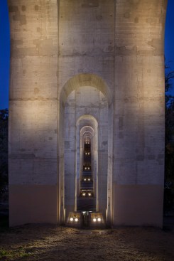 A view looking across the site shows how the pairs of luminaires, in their concrete enclosures, are positioned at each pier leg.