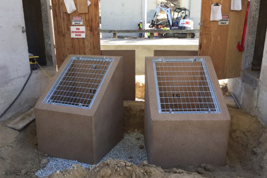 A view of the concrete enclosures, with their access grates, that house the luminaires.