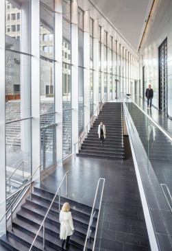 A grand staircase connects the ground floor and first floor inside the tower, and the street level to a plaza outside.
