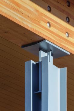 The designers wanted to blur the lines between the outdoors and indoors. Double-channel steel columns allow light and views of the landscape to slip through the building structure. Knife plate connections—thin steel plates mortised into wooden beams or anchored in concrete—extend 6 inches above and below the tops and bottoms of the columns, giving the structure an open feel.