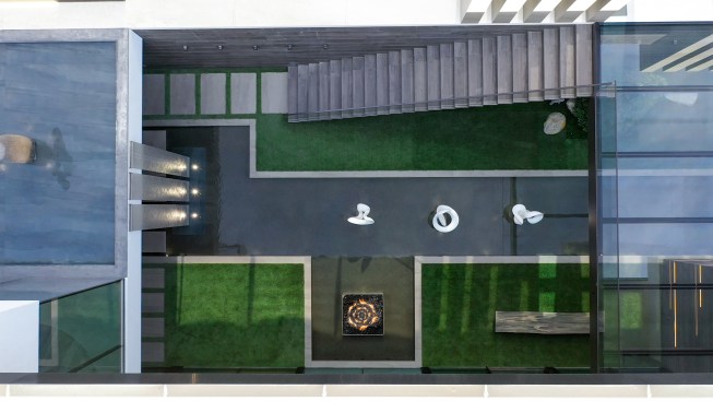 Serenity Indian Wells glass wall modern mansion with luxury car display garage