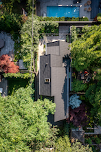 Supplied by Agway Metals, the large, flat-lock tiles wrap the exterior walls, columns and steeply pitched roof.