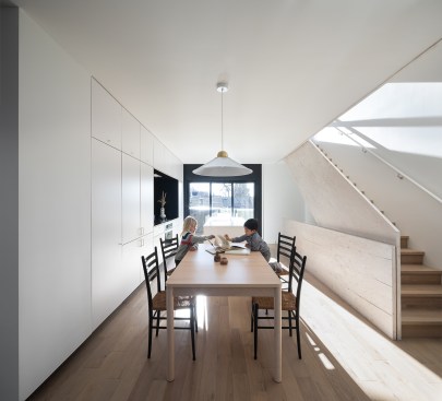A reduced ground floor footprint creates a covered courtyard space at the entry of each unit