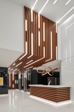 The security desk was pulled more prominently into the space, crowned with a custom light fixture designed by artist John Procario with Todd Merrill Studio.