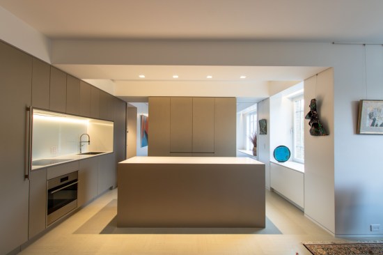 The kitchen is small but lives large. As a pied-a-terre, the owners would not be doing heavy cooking. A small island houses a wine fridge and microwave. An appliance garage hides all the clutter. And two hidden doors pocket into the center volume, which can be closed for privacy to the bedroom.