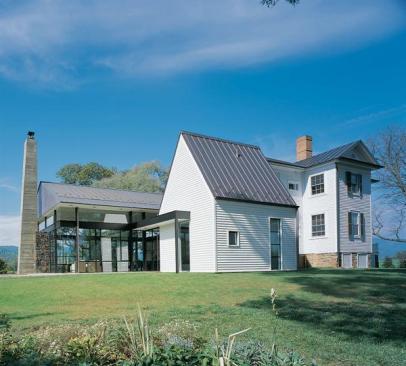 From the pavilion's roofline to the bath/mudroom's white clapboard cladding, Gurney's design pays tribute to the old house. But Modern lines and the use of steel and glass give the addition a distinctive identity.