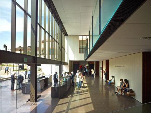 The Bram Goldsmith Theater lobby overlooks a terraced courtyard through a west-facing window wall. 