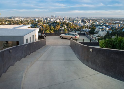 Los Tilos Hollywood Hills modern home pool and fire feature on terrace entertainment area with view.
