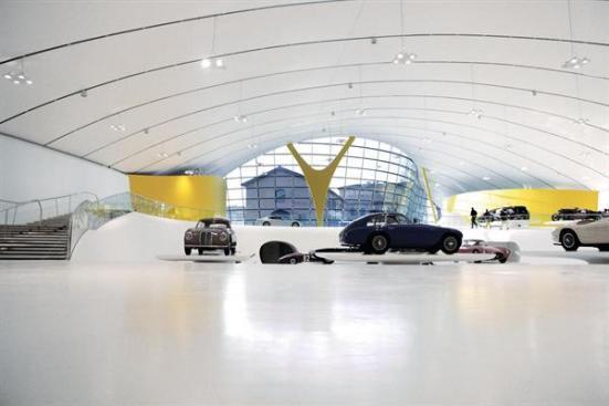 Inside%2c+the+ceiling+plane+is+far+less+brightly+hued+that+the+vivid+exterior%3a+White+PVC+fabric+is+stretched+taut+over+web+trusses%2c+akin+to+the+ceiling+of+a+car.