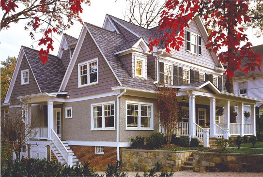 A second gable added to the home’s east fa&ccedil;ade gives it a pleasing symmetry (opposite). Fresh white trim highlights its traditional style and materials.
