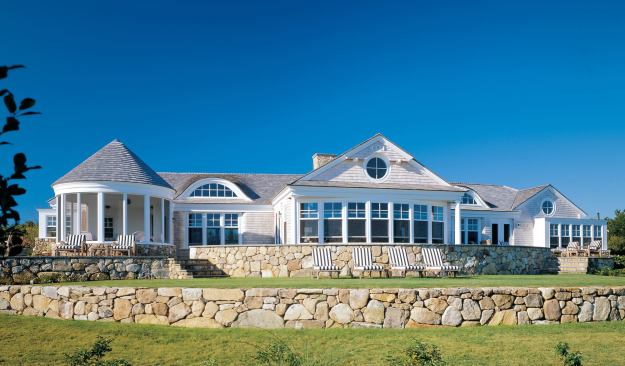 The variety of rooflines and room projections on the oceanfront elevation help make the house appear smaller than it really is.