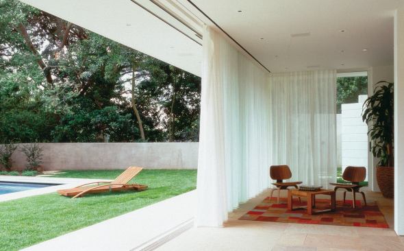 Custom Home Outdoors – Winter 2005  “Open House” from Pool Houses case study   Architect: Montalba Architects, Santa Monica, Calif.; Builder: Sarlan Builders, Santa Monica  This 680-square-foot pavilion features disappearing glass walls on three sides. A 42-foot cambered steel beam gives the gabled roof enough support so that concrete roof tiles don't put pressure on the sliding glass. Architect David Montalba strengthened the bond between pavilion and pool by making them the same size and shape.