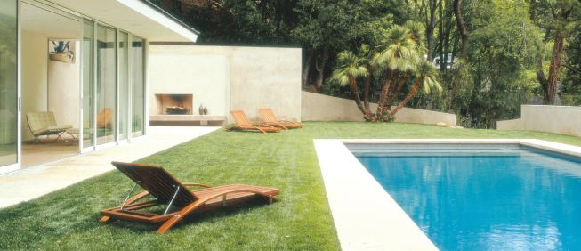 Custom Home Outdoors – Winter 2005  “Open House” from Pool Houses case study   Architect: Montalba Architects, Santa Monica, Calif.; Builder: Sarlan Builders, Santa Monica  This 680-square-foot pavilion features disappearing glass walls on three sides. A 42-foot cambered steel beam gives the gabled roof enough support so that concrete roof tiles don't put pressure on the sliding glass. Architect David Montalba strengthened the bond between pavilion and pool by making them the same size and shape.