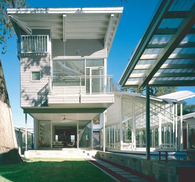 Metal louvers and deep overhangs help cool the two-story main house, which in turn shelters the rest of the compound from the intense Texas sun.