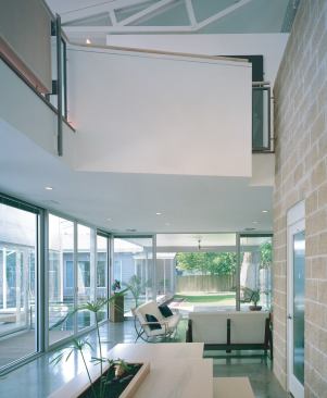 Soaring volumes and handmade furnishings distinguish Chuong Nguyen's residence. Across the lily pond lies the outdoor kitchen he and his brother Chung designed for their parents.