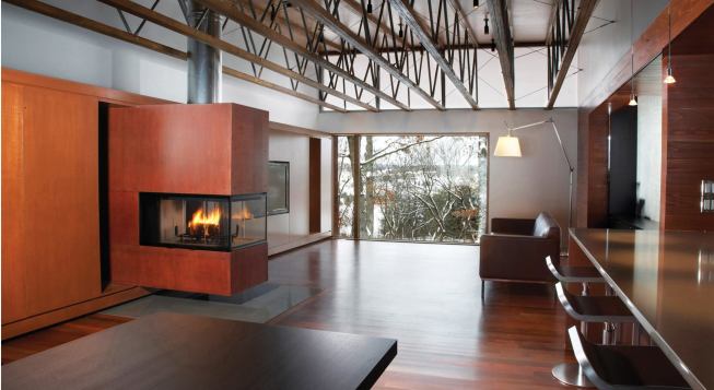 A new system of wood-and-steel roof trusses opens the interior to a full-length clerestory.