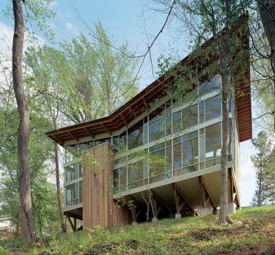 Grand Award - Custom Home / Less Than 3,000 Square Feet

Strickland-Ferris Residence, Raleigh, N.C.



Frank Harmon Architect, Raleigh



According to the home's architect, Frank Harmon, lifting it up was the surest way to minimize disturbance to the steeply sloped site. A butterfly roof channels the flow of rainwater off the house. Deep overhangs work with the mature trees outside to shade the dramatic, glass-walled main living space.
