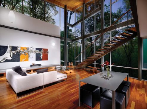 Deep overhangs work with the mature trees outside to shade the dramatic, glass-walled main living space.