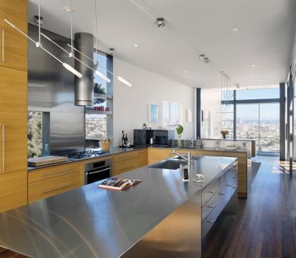 The stainless steel island refelcts the natural light deeper into the long, narrow foot print.