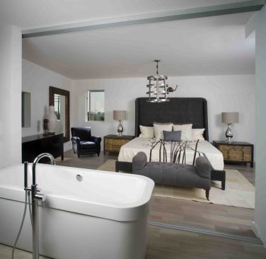 In the fourth model unit, designed by furniture company Cisco Bros., a sliding door separates the bedroom from the bathroom, an element that saves space while lending a unique architectural touch.