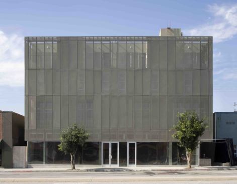 The metal façade surrounding The Lofts at Cherokee Studios creates a striking architectural element while providing privacy-maintaining light and ventilation. The ground floor will house retail shops.