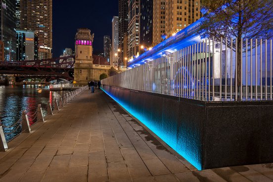 At The Water Plaza, color-changing linear LED fixtures are concealed in slots to highlight the stone wall of the water feature.