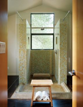 In the master bath at the Dutcher Creek Residence, the shower's concrete pan and glass wings extend into the room, forming a transparent "front porch" for toweling off.
