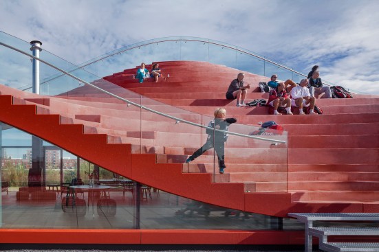 The terraced seating likens an amphitheater setup, but features alternating curves from top to bottom. 