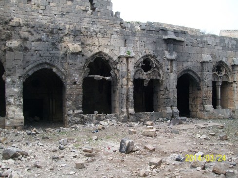 Crac des Chevaliers' exterior as of 2014, which is blackened and damaged from the explosions.