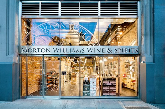 With the Entice Series Entrance System, premium exterior retail spaces—such as this boutique wine and spirits shop in New York—are able to achieve the elegant appearance of a monolithic heavy-glass entrance while satisfying new energy code requirements.