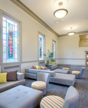 As part of the adaptive reuse of a former dormitory on the Cardinal Cushing Centers campus, the historic chapel was converted into a community room for residents.