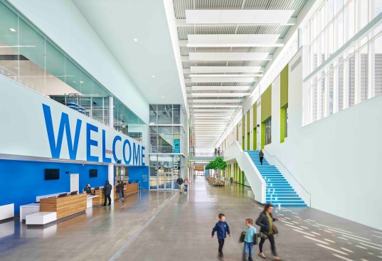 3.	A big Welcome sign greets visitors in the triple height lobby which runs the length of the new building.