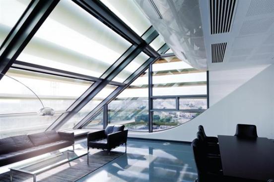 On+the+western+edge+of+the+building%2c+an+office%27s+slanted+glass+wall+offers+views+out+over+Montpellier.