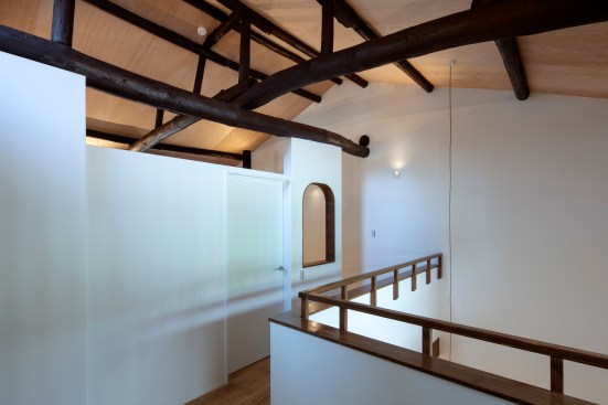 The new vault ceiling exposes the aged original log roof structure.