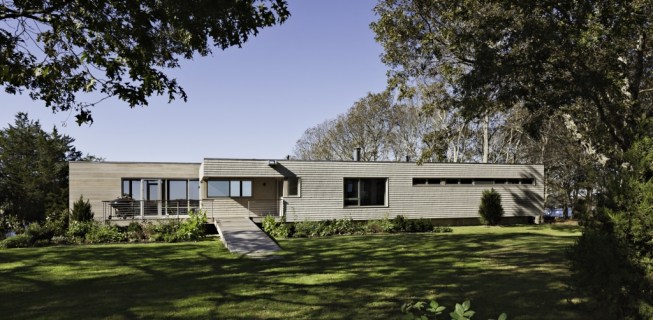 Entrance to the house is by way of a wood and steel ramp, up to an elevated deck