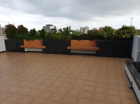 Benches surrounded by Green and Planter Boxes at the Roof Terrace level. 