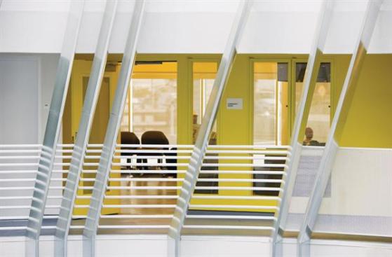 A community room opens onto the louvered central courtyard. Painted yellow to identify it as a public space and set it apart from the surrounding units, the room provides space for residents to relax, watch television, and take part in group activities. Next door is a laundry center that serves the entire complex.