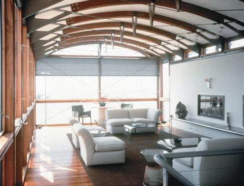 The house's two glassenclosed wings stretch toward the ocean, gathering light and views. Vaulted ceilingsamplify the feeling of spaciousness inside.