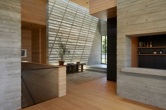 The use of simple, yet contemporary, materials is central to the minimalist design philosophy. Industrial board form concrete, white oak shiplap wall cladding, French manor oak flooring, oil rubbed bronze wall panels, and painted steel show deference to the picturesque surroundings.  