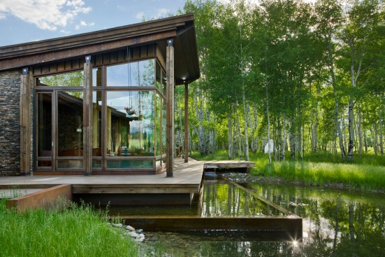 Exterior, horizontal, living room pod with water feature surround looking into aspen grove, Kahlbetzer residence, Wilson, Wyoming; Ward + Blake Architects