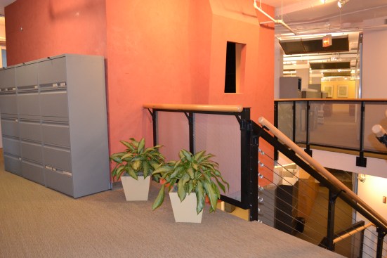 The existing office space was marked by closed offices, high cubicle walls, and rooms that divided the space.