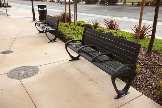 Trio Benches shown in 6 foot, backed configuration with Black Texture powdercoated frame, extruded aluminum slats and two armrests; also shown Urban Renaissance Litter & Recycling Receptacle at BART, Pleasant Hill/Contra Costa Centre Station, Walnut Creek, California