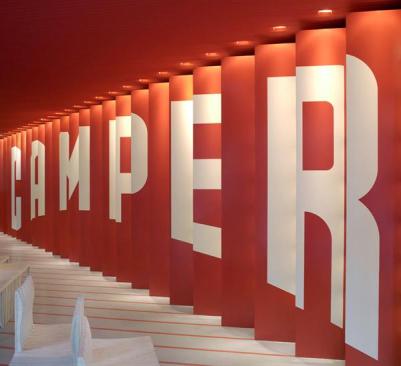 %22House+of+Shoes%22+interior.+A+billboard+along+one+wall+has+shelves+mounted+behind+each+panel%2c+allowing+it+to+double+as+a+shoe+display.