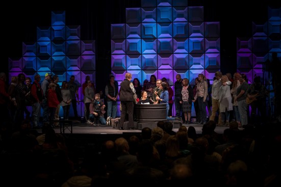The translucent wall panels were rear-illuminated in subdued tones to create a dramatic backdrop for the baptism pool that is in the spotlight in the foreground.