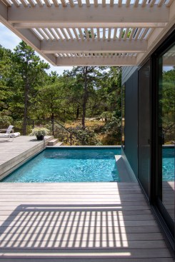 The guest suite is connected to the pool deck with this bridge piece, covered in a cedar slat trellis.