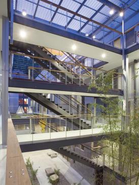 The architects used as much of the ruined building as they could. Corrugated metal, bright colors, and the old crane - now fixed in place - preserve the industrial flavor.