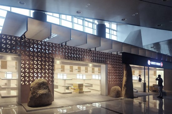 DFS, a new retail pavilion in the Van Don International Airport in Vietnam, features a transparent façade that allows travelers to glimpse the beauty products on display inside.